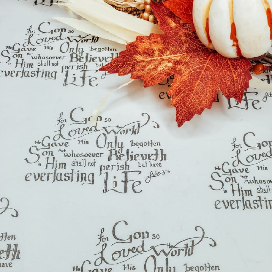 Christian wrapping paper with fall leaf and pumpkin placed on top